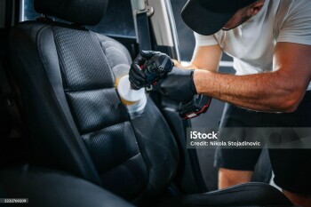 A man cleaning car interior, car detailing in Carwash service, close up