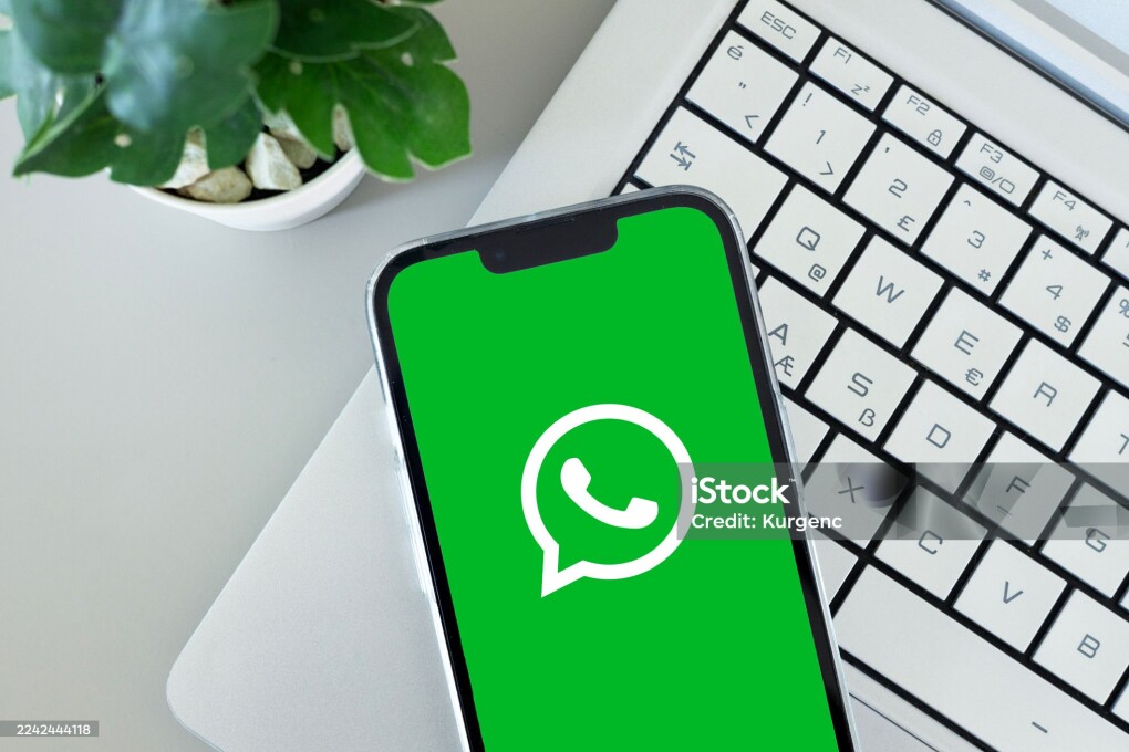 WHATSAPP app icon on smartphone screen over laptop. ADANA-TURKEY - 20 OCTOBER -2025