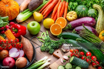 Freshly picked organic fruits and vegetables on kitchen table. Preparing healthy vegetarian meal with juicy ingredients. Food to improve the inmune system.