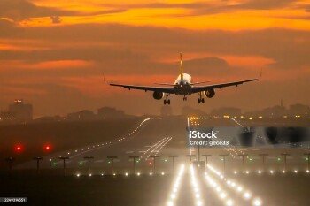 Passenger airplane landing at dusk
