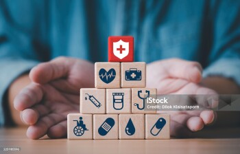Businessman hand giving and showing a wooden blocks which symbolizing medical protection treatment support and essential healthcare services for patient wellbeing as a health insurance concept