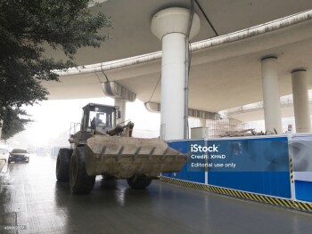 "Chengdu, China - January 15, 2013: The construction vehicles are building flyovers to alleviate the gridlock in ChengDu Shu Po Road, but the dust brings the big fog to cause huge pollution."