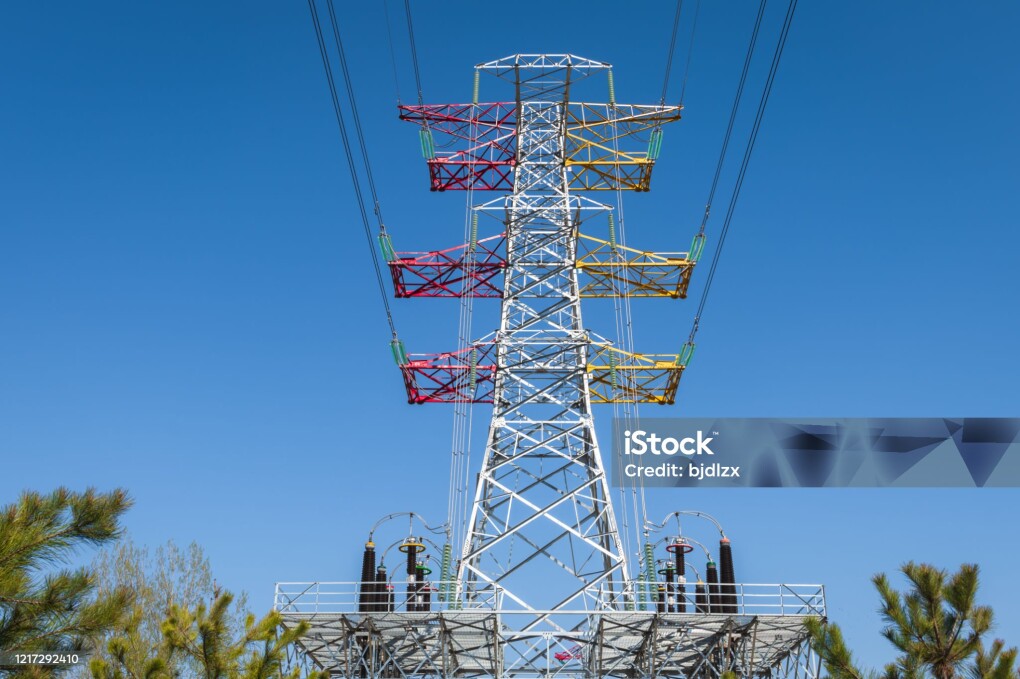 High voltage tower under blue sky
