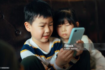 Asian children playing cellphone