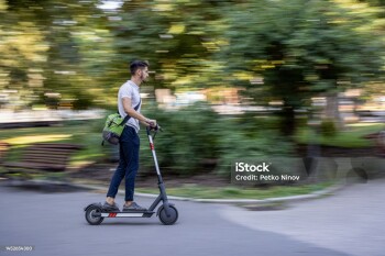 Motion blurred image of man with e-scooter