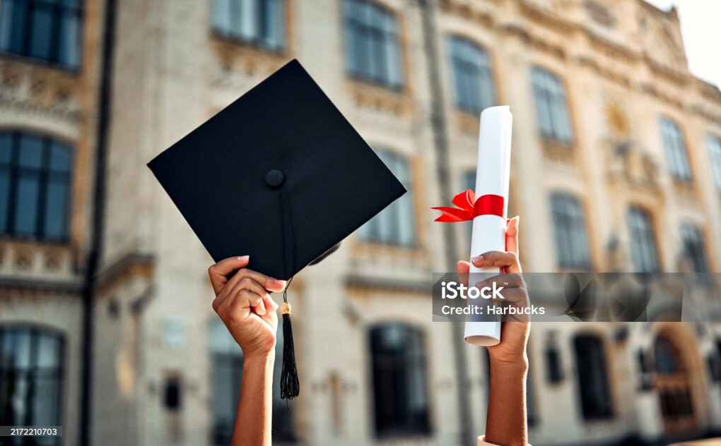 Cropped image of graduate holding academic hat and diploma with red ribbon. Happy graduation, bright future, success and confidence.
