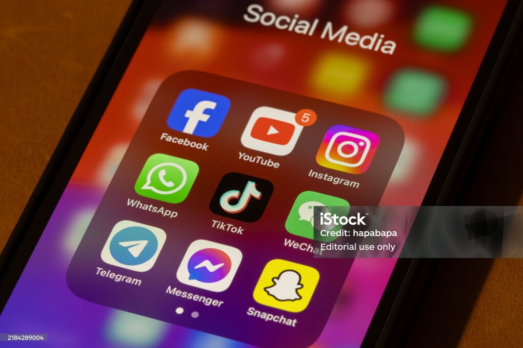 Portland, OR, USA - Nov 11, 2024: Some of the most popular social media apps by number of monthly active users, including Facebook, YouTube, Instagram, WhatsApp, TikTok, WeChat, Telegram, Messenger, and Snapchat, are seen on an iPhone.