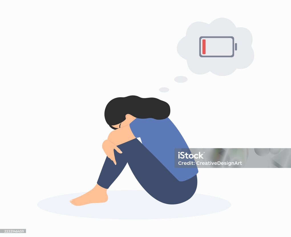 Tired Woman With A Low Battery Symbol Above Her Head Sitting On Floor And Hugging Her Knees. Depression, Emotional Burnout And Mental Health Problems