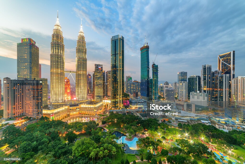 Evening aerial view of the KLCC Park and the Petronas Twin Towers in Kuala Lumpur, Malaysia. The urban park in Kuala Lumpur City Center is a popular tourist attraction of Asia. Kuala Lumpur skyline.