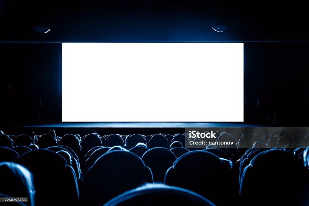 People in the cinema watching a movie. Blank empty white screen.