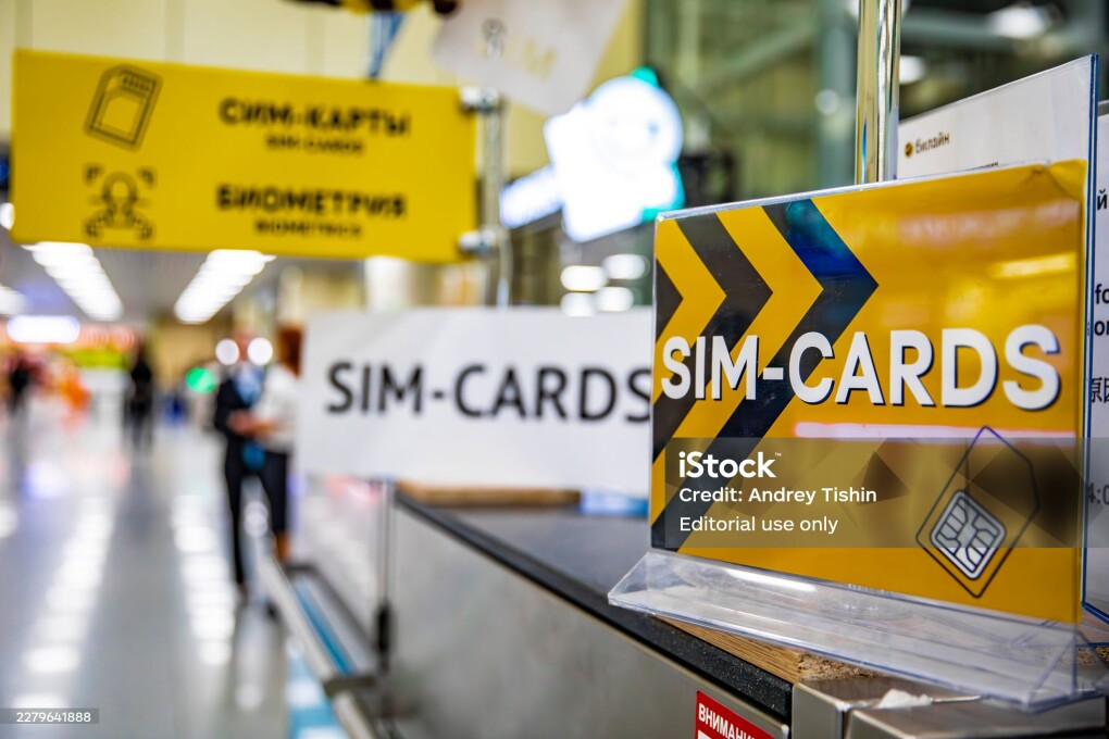 Moscow, Russia - 22 April 2026: Yellow stand with the inscription SIM-CARDS in the hall of the Domodedovo airport