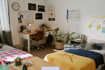 Wide angle shot of teenager bedroom with study desk, school supplies, calendar, posters, beds, showing student organization, youth lifestyle. For education, dorm, parenting, back to school marketing