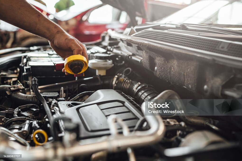 An auto mechanic working on a car engine, technical car inspection in service