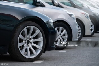 A lot of cars in a rows. Used car sales.