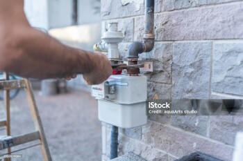 Technician Repairing Pipe And Gas Meter