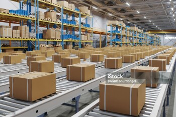 Automated Warehouse Conveyor System with Cardboard Boxes in Distribution Center