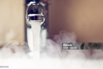 water tap with hot water steam, closeup view