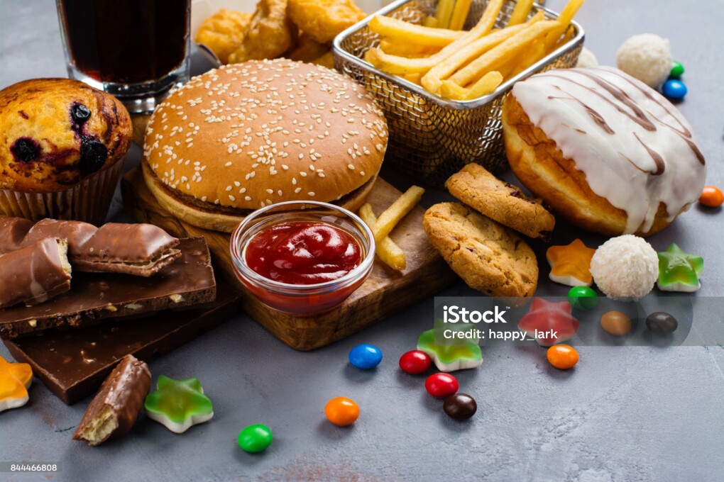 Assortment of unhealthy products that's bad for figure, skin, heart and teeth. Fast carbohydrates food. Space for text