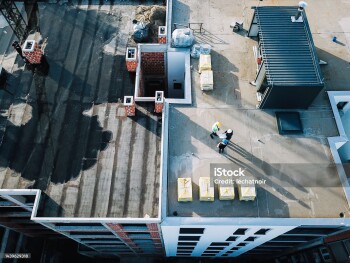 Workers on top of the building under construction.