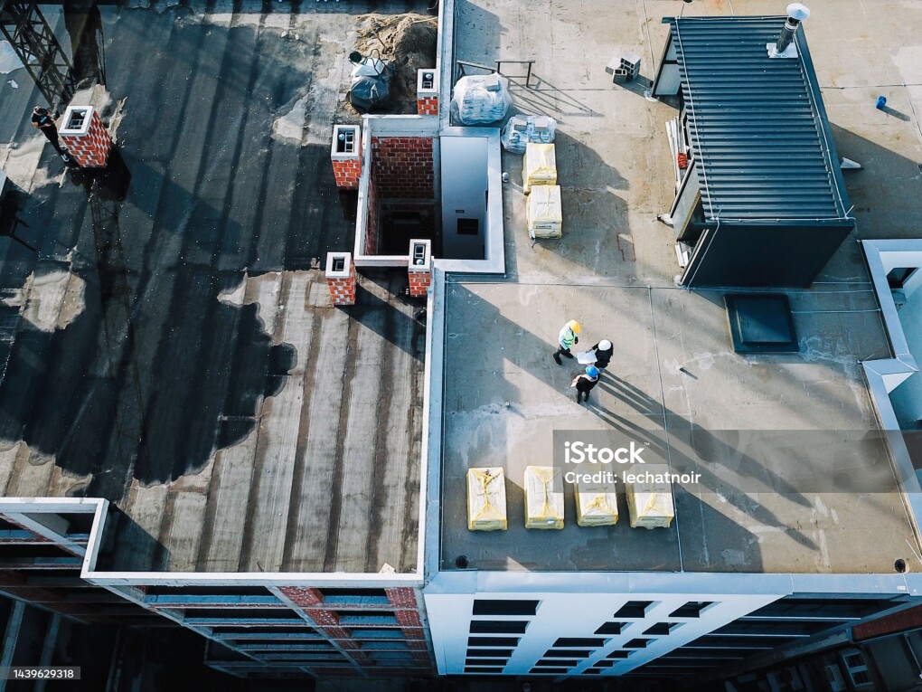 Workers on top of the building under construction.