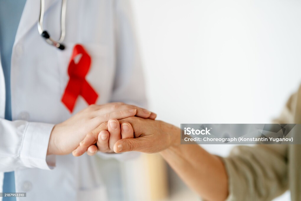 Colour ribbon for concept of illness awareness. Female patient listening to doctor in medical office. Raising knowledge on people living with disease.