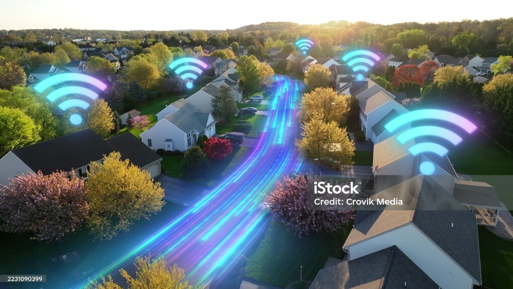 Wifi over modern American houses. Golden hour sunset with futuristic neighborhood. Wifi internet connected broadband in suburban town. Internet of things. Aerial. Graphic