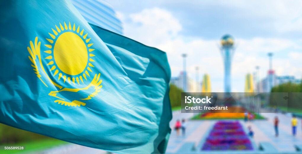 Wind develops flag of the Republic of Kazakhstan in bacground Astana